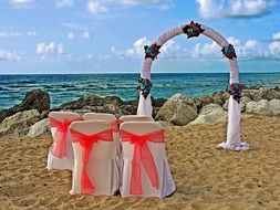 altar and wedding chairs on the beach