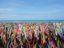 colored ribbons on the beach fence