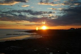 orange sun over the horizon of the beach