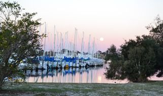sunset over yachts at the pier in australia