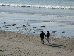 Couple is walking on the seaside in summer