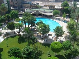 top view of luxury resort with swimming pool in garden