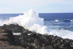 waves beat against the rocks on the beach