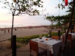 tables with chairs in a restaurant on the coast in Indonesia