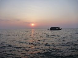 boat in ocean view from coast of Kerala, India