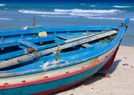 blue boat on the ocean beach