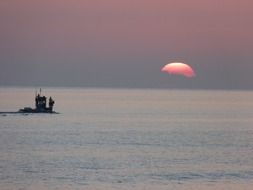 boat at sea at sunset horizon