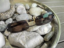 sunglasses lie on the stones