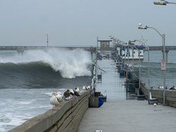 huge waves over the ocean pier