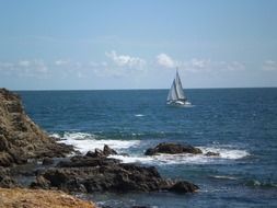 rocky coast and sailing boat