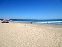 tourists relax on Kuta Beach