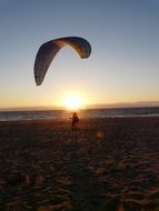 paragliding at sunset