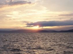 sunset behind the clouds on lake balaton