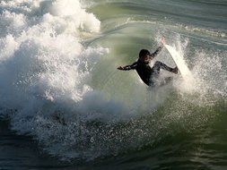 surfer doing tricks in Huntington Beach