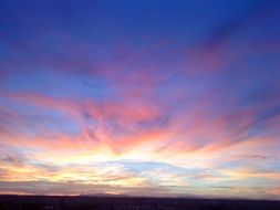 picturesque sunset sky with pink and golden clouds