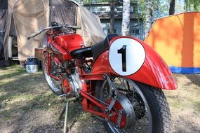 red retro motorbike at camping