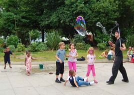 children game with soap bubble