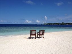 beach chairs on the island of bandos in the maldives