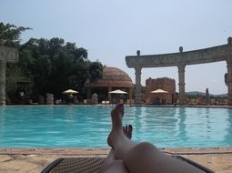 relaxing by the pool with turquoise water