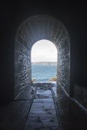 narrow tunnel to ocean beach