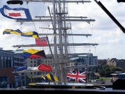 different flags on the ship's mast