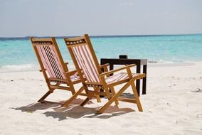 wooden sun loungers on the beach by the sea