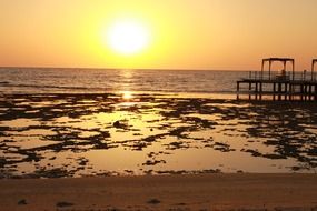 evening sky with sun over the beach