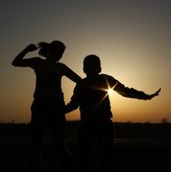 children silhouettes in yellow sunset