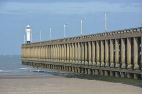 Lighthouse on pier sea sand beach