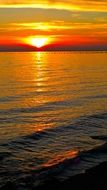 orange bright sunset over the water