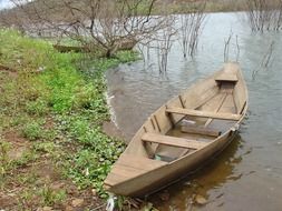 wooden empty boat on water