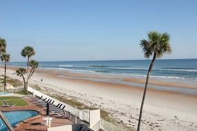 fenced beach with lawn and pool on ocean coast, florida, alabama