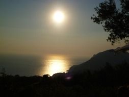sun in the sunset over the hill