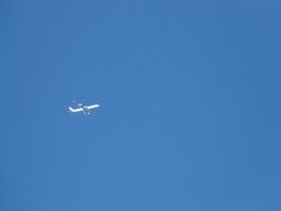 white plane on the blue sky