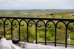 glass of wine near the railing
