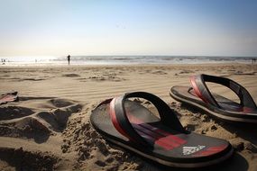 Adidas slippers on the beach