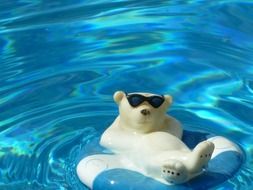 ceramic figure of a polar bear swimming in the pool