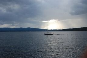 boat in the sun from behind the clouds