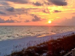 sunset over the ocean water at dusk