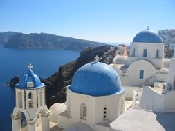 panoramic view of traditional architecture on santorini island and rocky coast