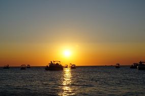 Wonderful orange sea sunset boats