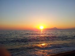 sunset on the ocean horizon in italy