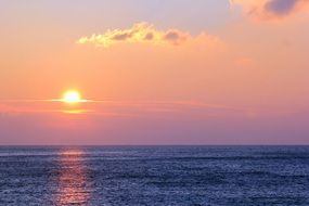 pink sunset on the horizon over the ocean