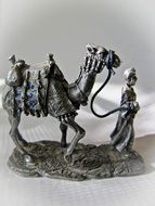statuette of camel and arab