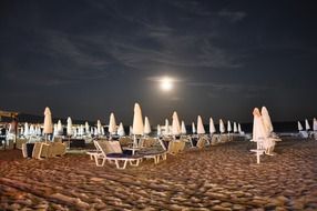 beach equipment at full moon night
