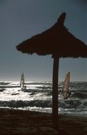 distant view of surfers in the bright sun