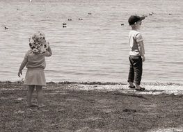 Black and white image of children on the beach
