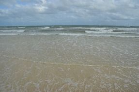 clear foamed waves on sand beach