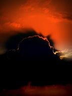 Red sunset on a black cloud background