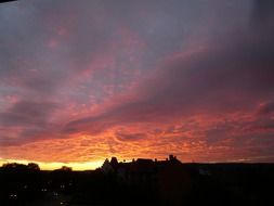 colorful sunset in the clouds over the silhouettes of the city